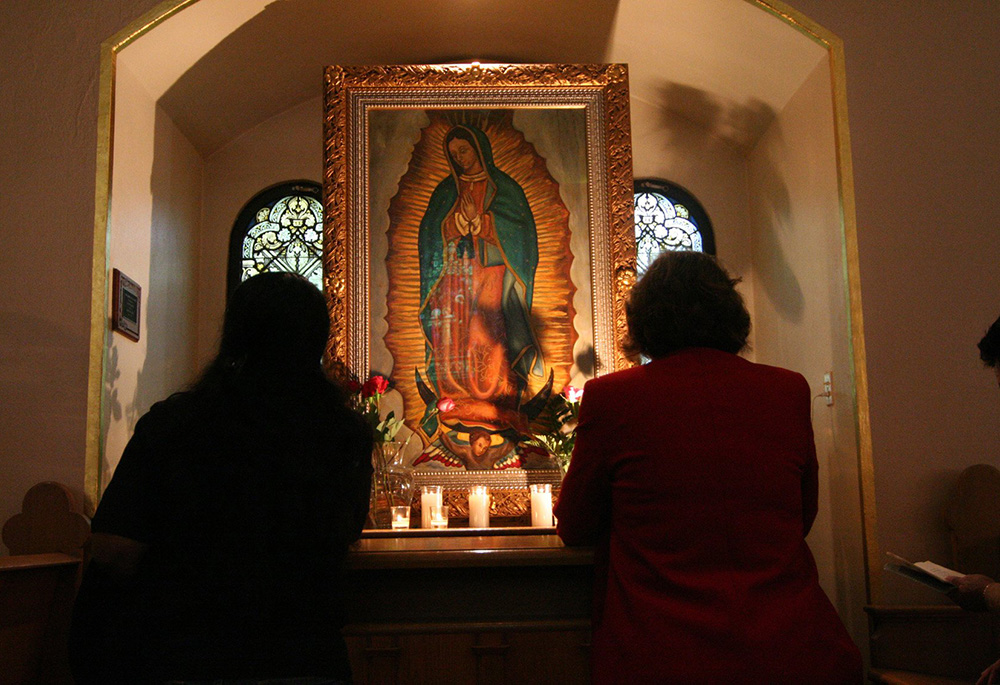 Two women pray before a shrine dedicated to Our Lady of Guadalupe in this 2006 file photo. Contributor Catalina Morales Bahena always felt that her late paternal grandmother and Our Lady of Guadalupe "were so important to my formation as a Catholic woman. I know they both guide my path in my ministry work." (CNS/The Catholic Sun/Robert DeFrancesco)
