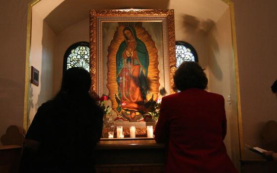Two women pray before a shrine dedicated to Our Lady of Guadalupe in this 2006 file photo. Contributor Catalina Morales Bahena always felt that her paternal grandmother and Our Lady of Guadalupe "were so important to my formation as a Catholic woman. I know they both guide my path in my ministry work." (CNS/The Catholic Sun/Robert DeFrancesco)