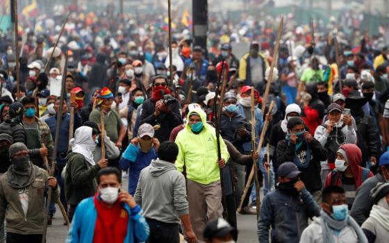 Demonstrators hold spears as they take part in a protest against Ecuadorian President Lenin Moreno's austerity measures in Quito, Ecuador, Oct.1, 2019. Ecuadorian observers at the Synod of Bishops for the Amazon at the Vatican are keeping an eye on massive protests that have claimed the lives of at least five people in their country. (CNS photo/Carlos Garcia Rawlins, Reuters) 