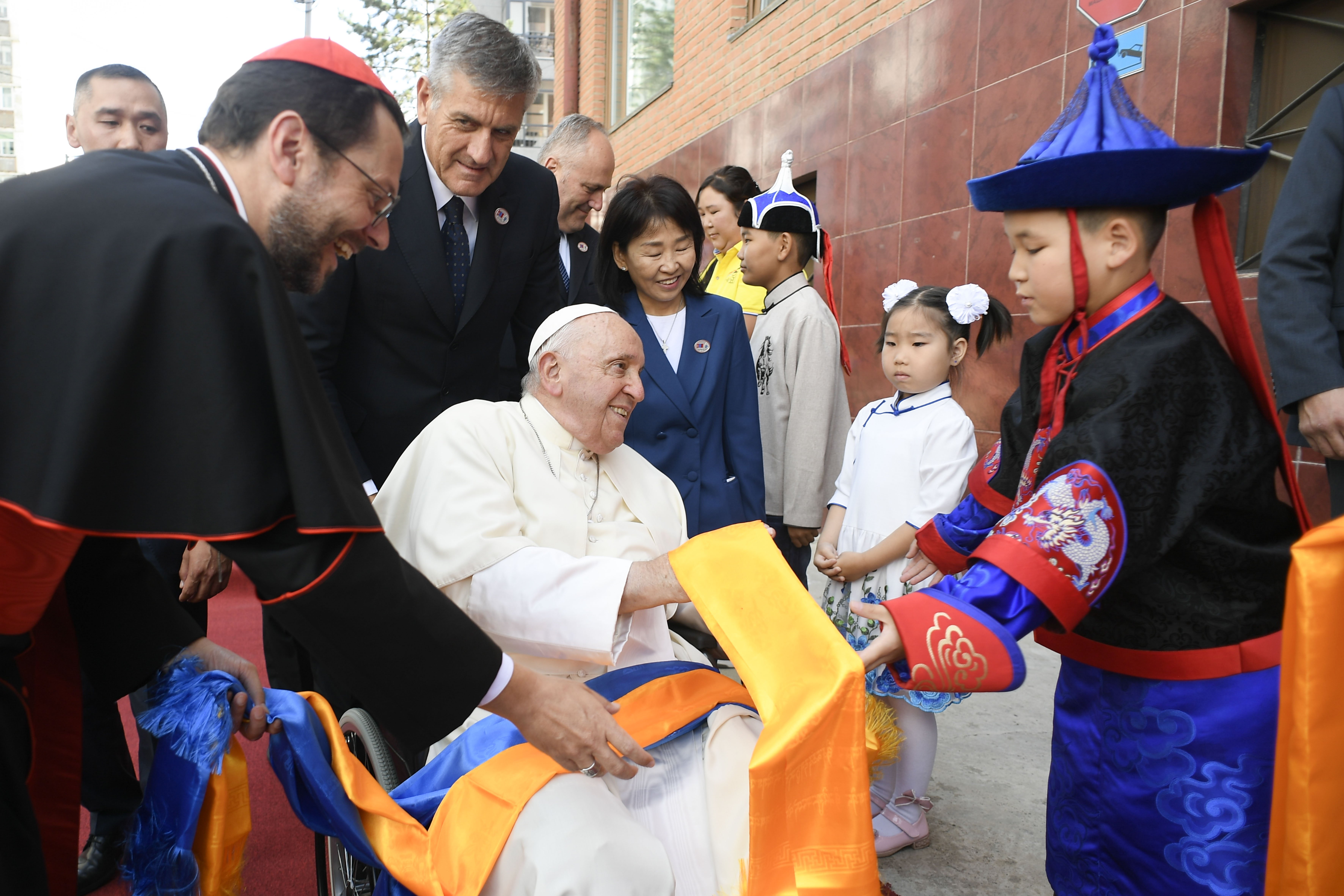 A boy gives Pope Francis scarves as he arrives at the headquarters of the Apostolic Prefecture of Ulaanbaatar, Mongolia, Sept. 1, 2023. Cardinal Giorgio Marengo, the prefect, will host the pope at the prefecture during his four-day visit to the country. (CNS photo/Vatican Media)